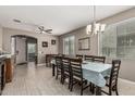 Bright dining room with elegant tile flooring and a formal dining table for eight guests at 1723 N Hillcrest --, Mesa, AZ 85201