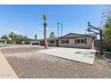 Charming home boasts desert landscaping, complemented by palm trees and a basketball court at 1911 E Lawrence Rd, Phoenix, AZ 85016