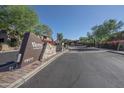 View of the Venu at Grayhawk community entrance with stone accents, beautiful landscaping, and clear signage at 19777 N 76Th St # 2142, Scottsdale, AZ 85255