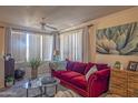 Inviting living room showcasing a red sofa, modern decor, and plenty of natural light, creating a cozy ambiance at 19777 N 76Th St # 2142, Scottsdale, AZ 85255