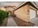 Single-level home featuring desert-friendly landscaping, a bench, and a convenient two-car garage at 2006 W Gold Dust Ave, Queen Creek, AZ 85144