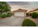 Well-maintained home with a two-car garage, desert landscaping, and a clean, tidy front yard at 2006 W Gold Dust Ave, Queen Creek, AZ 85144