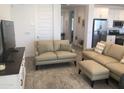 Stylish living area with neutral-toned furnishings, light walls, and tile floors at 25109 N 173Rd Dr, Surprise, AZ 85387