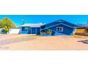 Charming single-story blue home with a tidy front yard and desert landscaping under a bright blue sky at 3115 N 55Th Ave, Phoenix, AZ 85031
