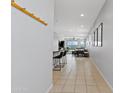 Bright hallway with tile flooring, coat rack, and views into the open-concept living and dining areas at 3597 E Henson St, San Tan Valley, AZ 85140