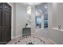 Elegant foyer with a decorative tile floor, high ceilings, and an open view into the living spaces at 40613 N Candlewyck Ln, Anthem, AZ 85086