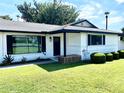 A charming home with fresh landscaping, including well-placed shrubbery and a bright green lawn at 541 W Marlette Ave, Phoenix, AZ 85013