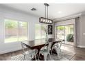 Dining room with shiplap walls, modern lighting, and views of the backyard pool at 6317 S Banning St, Gilbert, AZ 85298