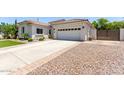 Long concrete driveway leads to a two-car garage, with low maintenance landscaping at 6317 S Banning St, Gilbert, AZ 85298
