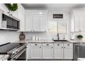 Updated kitchen featuring white cabinets, granite countertops, and stainless steel appliances at 6317 S Banning St, Gilbert, AZ 85298