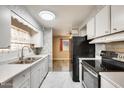 Efficient kitchen featuring stainless steel appliances and white cabinets with a view to living area at 8103 E Southern Ave # 170, Mesa, AZ 85209