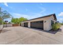 Attached 3-car garage with extra parking space and basketball hoop, perfect for Gathering activities at 8213 E Sharon Dr, Scottsdale, AZ 85260