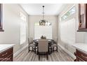 Cozy dining area with modern light fixture and big windows provides lots of natural light at 8848 E Conquistadores Dr, Scottsdale, AZ 85255