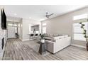 Open-concept living room boasts wood floors, neutral paint, and a view into the connected kitchen at 8848 E Conquistadores Dr, Scottsdale, AZ 85255