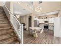 Spacious living room featuring staircase, chandelier, dining area and kitchen at 1367 S Country Club Dr # 1331, Mesa, AZ 85210