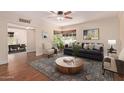 Inviting living room featuring hardwood floors, a ceiling fan, and an abundance of natural light at 152 W 2Nd St, Mesa, AZ 85201