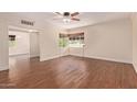 A spacious living room with sleek wood floors and ample natural light from the windows at 152 W 2Nd St, Mesa, AZ 85201