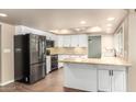 Bright kitchen featuring white cabinetry, stainless steel appliances, granite countertops and a skylight at 1862 E Tulane Dr, Tempe, AZ 85283