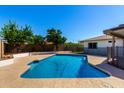 Sparkling in-ground pool surrounded by a patio and lush landscaping, perfect for outdoor enjoyment at 1862 E Tulane Dr, Tempe, AZ 85283