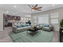 Open-concept living room with modern decor, plush seating, and an inviting atmosphere at 19606 W Grant St, Buckeye, AZ 85326