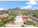 Birds-eye view of house with a red tile roof, landscaped yard, and majestic mountain views at 2016 E Orangewood Ave, Phoenix, AZ 85020