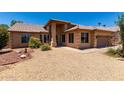 Attractive single-story home featuring desert landscaping and a terracotta roof under a sunny sky at 20670 N 41St Ave, Glendale, AZ 85308