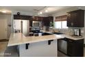 Stylish kitchen with stainless steel appliances, black sink and speckled countertops at 2317 E Mohave Ln, Apache Junction, AZ 85119