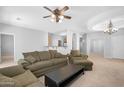 Open concept living room featuring a ceiling fan, a chandelier, and views of the kitchen at 2565 S Signal Butte Rd # 30, Mesa, AZ 85209