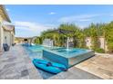 Lush pool area featuring a kayak, water features, and a relaxing spa, perfect for summer days at 2652 E Pelican Ct, Gilbert, AZ 85297