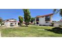 View of exterior with red roofs and landscaped green lawn at 2831 E Waltann Ln # 1, Phoenix, AZ 85032