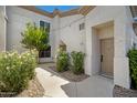 Charming condo entrance with well-maintained landscaping and cozy walkway at 3236 E Chandler Blvd # 2018, Phoenix, AZ 85048
