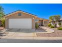 Charming single-story home features a two-car garage and low maintenance desert landscaping at 3301 S Goldfield Rd # 1048, Apache Junction, AZ 85119