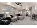 Spacious living room with vaulted ceilings, fan, large windows, and comfortable seating at 3301 S Goldfield Rd # 1048, Apache Junction, AZ 85119