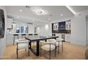 Open-concept kitchen with bar seating, black table, and modern finishes, creating a cozy atmosphere at 3800 E Lincoln Dr # 31, Phoenix, AZ 85018