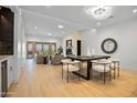Bright, open living room with light floors, stone fireplace, recessed lighting, and outdoor views at 3800 E Lincoln Dr # 31, Phoenix, AZ 85018