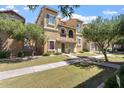 View of a two-story home showcasing architectural details and a green lawn at 4212 E Jasper Dr, Gilbert, AZ 85296