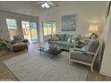 Bright and airy living room with a comfortable sofa, chair and view of the fenced backyard at 4608 W Gail Dr, Chandler, AZ 85226