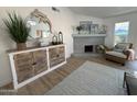 Stylish living room showcasing a decorative fireplace, nautical accents and a cozy atmosphere at 4608 W Gail Dr, Chandler, AZ 85226