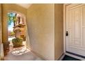 Home entryway featuring stucco walls, covered archway, and a light colored front door at 5234 E Carol Ave, Mesa, AZ 85206