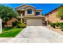 Charming two-story home featuring desert landscaping, tile roof, and an attached two-car garage at 5234 E Carol Ave, Mesa, AZ 85206