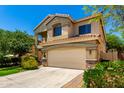 Charming two-story home featuring desert landscaping, tile roof, and an attached two-car garage at 5234 E Carol Ave, Mesa, AZ 85206