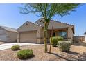 Charming single-story home featuring a neutral color palette, desert landscaping, and an attached two-car garage at 7224 W Puget Ave, Peoria, AZ 85345