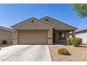 Charming single-story home featuring a neutral color palette, desert landscaping, and an attached two-car garage at 7224 W Puget Ave, Peoria, AZ 85345