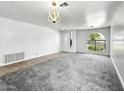 Bright living room with large windows, gray carpet and tile flooring at 7243 W Sandra Ter, Peoria, AZ 85382