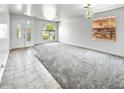 Bright living room with large windows, gray carpet and tile flooring at 7243 W Sandra Ter, Peoria, AZ 85382