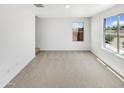 Neutral bedroom with carpet, two windows, and bright natural light at 8218 W Illini St, Phoenix, AZ 85043