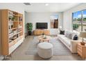 Bright living room featuring modern furnishings, striped rug, and a large window at 8218 W Illini St, Phoenix, AZ 85043