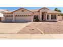 Charming single-story home featuring a well-maintained front yard, a two-car garage, and a welcoming entrance at 871 W Mesquite St, Gilbert, AZ 85233