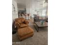 Cozy living room with comfortable seating, and a view of the open-concept kitchen and dining area at 9205 W Williams St, Tolleson, AZ 85353