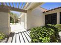 A covered entrance featuring a pergola and desert landscaping at 10538 E Gold Dust Cir, Scottsdale, AZ 85258